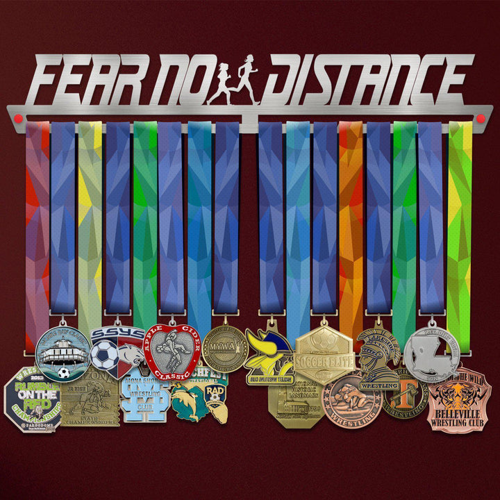 Fear No Distance Medal Hanger Display FEMALE holding colorful sports medals on a stainless steel rack with female runner silhouette design.